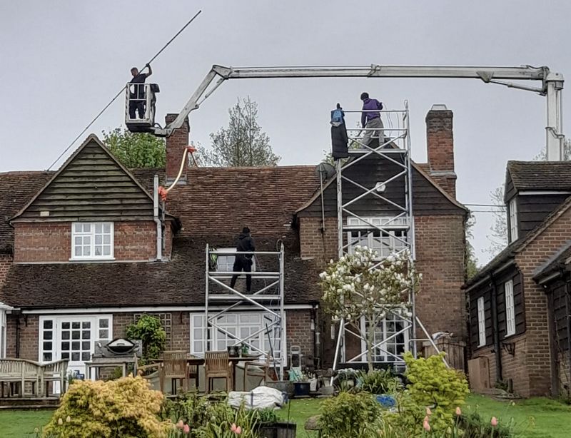 The Roof Moss Cleaners using cherry picker and scaffolding to clean roof safely and professionally in Soham, Cambridgeshire